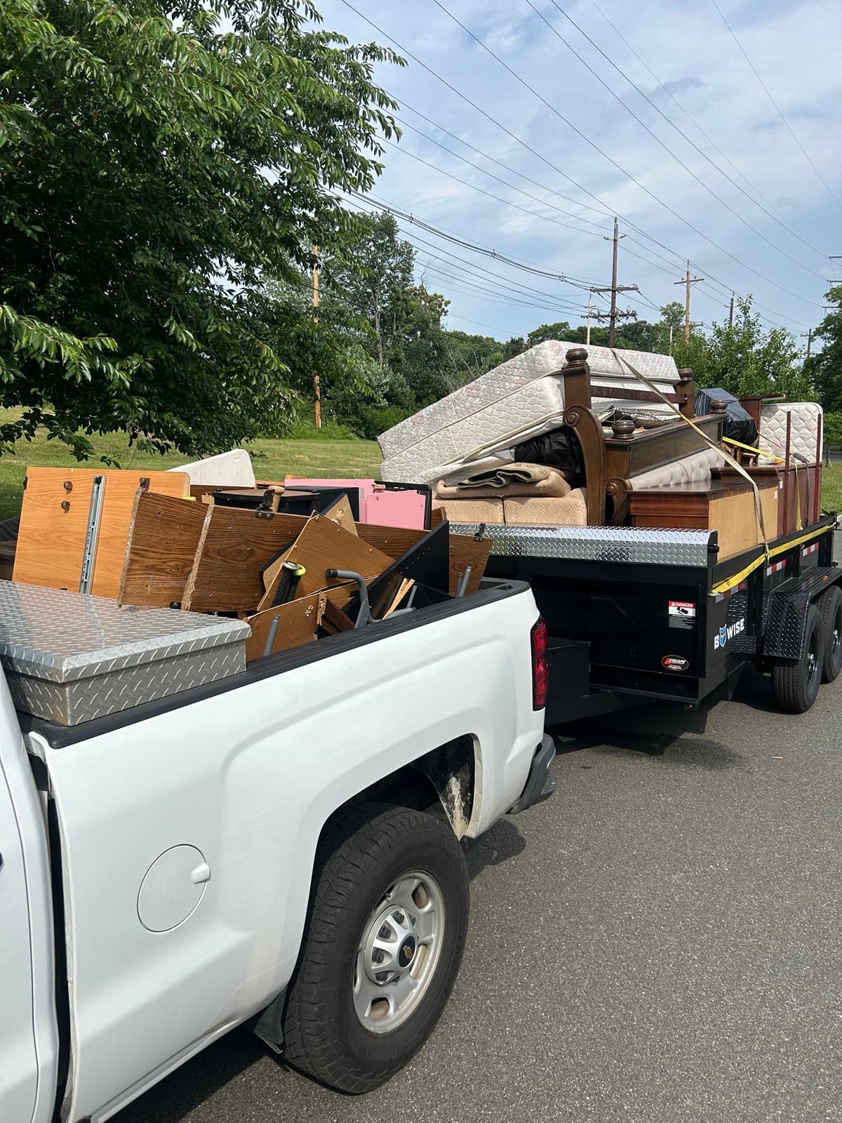 Truck and trailer loaded with furniture and debris from a cleanout